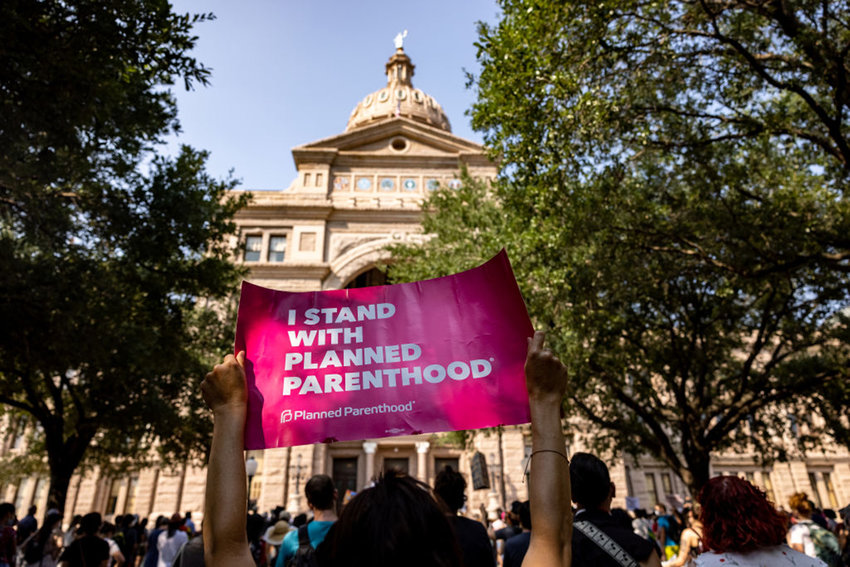 An abortion rights activist holds a sign in support of Planned Parenthood at a rally at the Texas State Capitol on Sept. 11, 2021, in Austin, Texas. (Jordan Vonderhaar/Getty Images/TNS)
