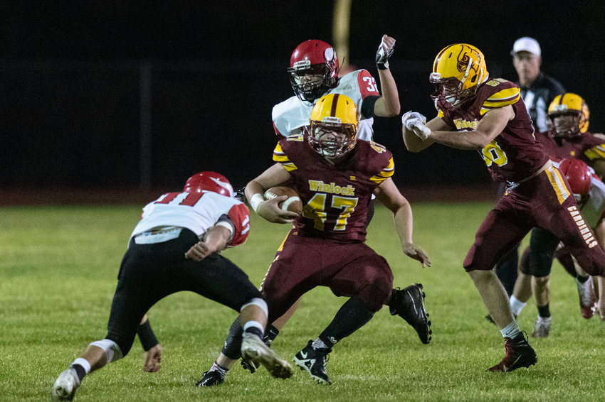 FILE PHOTO -- Winlock tailback Nolan Swofford breaks a tackle against Mossyrock Oct. 8.