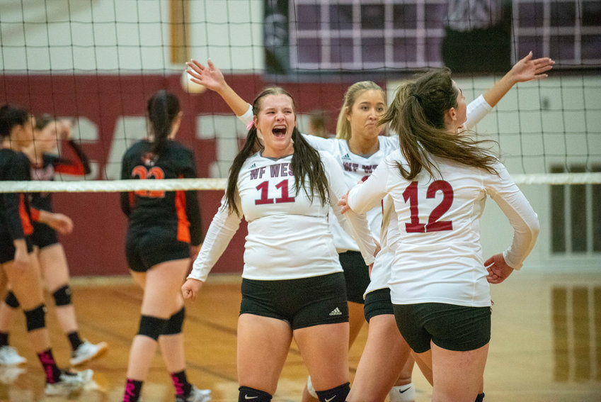 W.F. West's Savannah Hawkins (11) and her teammates celebrate after scoring a point against Centralia on Oct. 12, 2021.