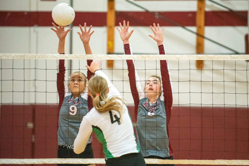 W.F. West's Ava Olsen (9) blocks a spike from Tumwater's Sydney Hanson (4), while Bearcats' Morgan Rogerson (6) also leaps for the block attempt on Oct. 14, 2021.
