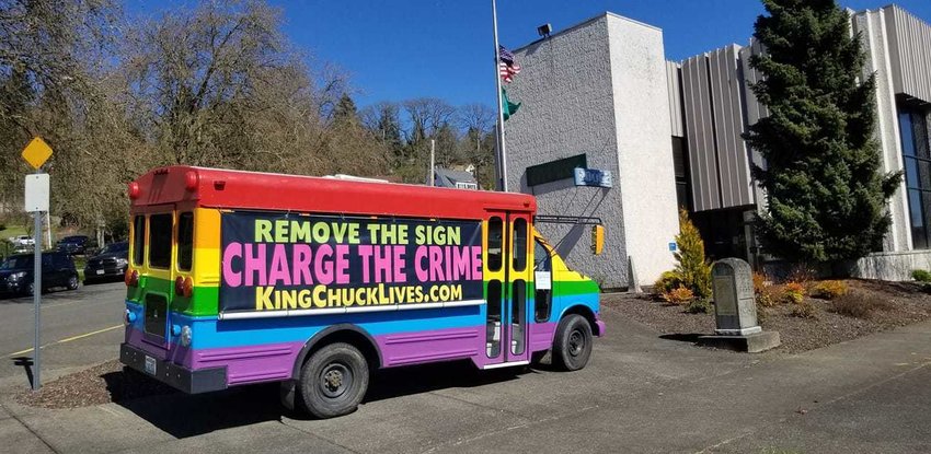 The Lollipop Guild&rsquo;s bus, bearing the message &ldquo;Remove the Sign, Charge the Crime, KingChuckLives.com,&rdquo; is pictured parked near Chehalis City Hall shortly before it was towed on April 12.
