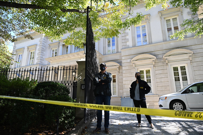 FBI agents stand guard outside the home of Russian oligarch Oleg Deripaska in Washington, D.C., on Oct. 19, 2021. FBI agents were conducting a search of the home, conducting &quot;court-authorized law enforcement activity&quot; at the home in a fashionable district of the U.S. capital. (Mandel Ngan/AFP/Getty Images/TNS)