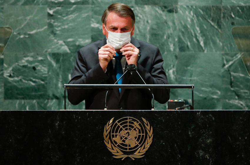 Brazil's President Jair Bolsonaro puts back on a protective face mask worn due to the coronavirus (COVID-19) pandemic after addressing the 76th Session of the U.N. General Assembly on Sept. 21, 2021 at U.N. headquarters in New York City. (Eduardo Munoz/Pool/Getty Images/TNS)