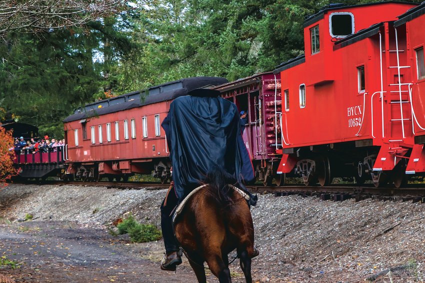 The Headless Horseman, also known as Centralia resident Curtis Kelley, rides alongside a train in this photograph he provided to The Chronicle.