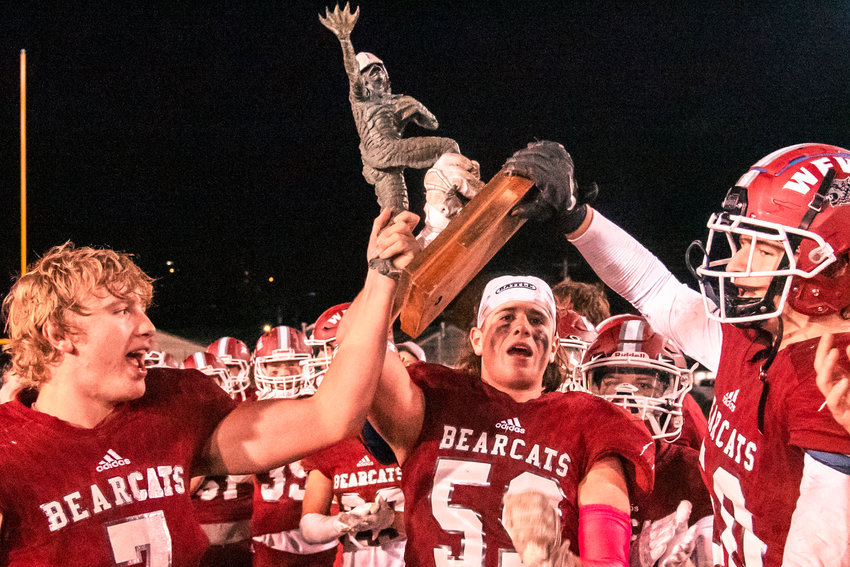 Bearcats hold up the Swamp Cup trophy Friday night in Chehalis.