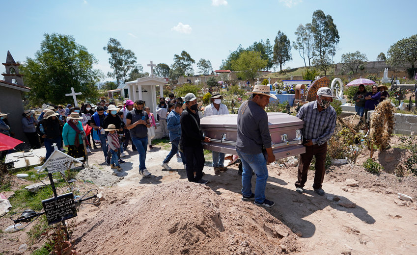The casket of Maria Eugenia Chavez Segovia is carried to its grave site at Tultepec Cemetery in Amealco de Bonfil, Mexico on Thursday, May 27, 2021. (Alejandro Tamayo/The San Diego Union-Tribune/TNS)