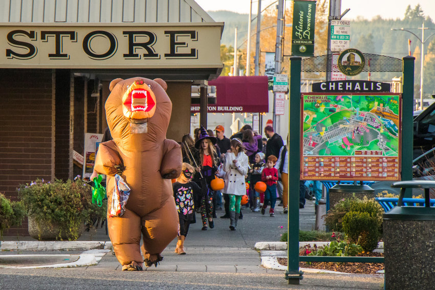 FILE PHOTO &mdash;&nbsp;Isaiah Grady sports a blowup bear costume as he runs down the sidewalk during Halloween festivities in Chehalis in 2019.