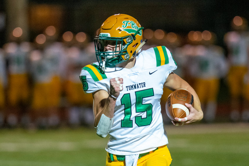 FILE PHOTO -- Tumwater&rsquo;s Ashton Paine (15) rushes for a first-quarter touchdown against Centralia Oct. 29.