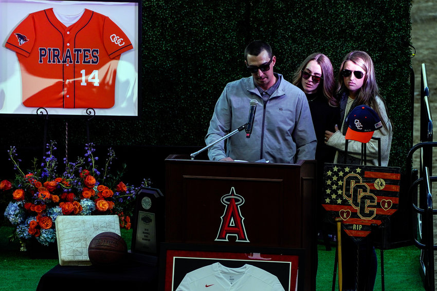 JJ Altobelli, accompanied by Lexi Altobelli and Carly Konigsfeld, speaks during a ceremony at Angel Stadium on Feb. 10, 2020, in Anaheim, California, to honor the lives of John, Keri and Alyssa Altobelli, who were among the nine killed in a helicopter crash that also claimed the lives of Los Angeles Lakers legend Kobe Bryant and his daughter Gianna. (Kent Nishimura/Los Angeles Times/TNS)