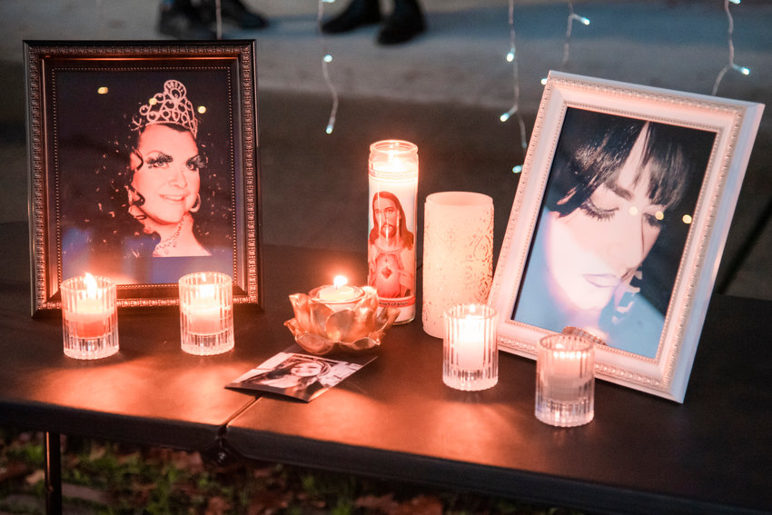 Candles illuminate photos during a vigil honoring the life of Rikkey Outumuro Friday in Centralia.