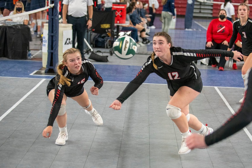 Mossyrock&rsquo;s Hailey Brooks, left, and Caelyn Marshall (12) dive for a loose ball against Oakesdale during the 1B state championship match Friday in Yakima.