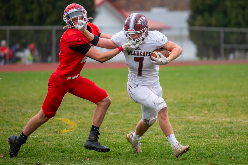 W.F. West running back Brock Guyette (7) stiff-arms a Prosser defender during the Bearcats&rsquo; state playoff game against the Mustangs on Saturday in Prosser.