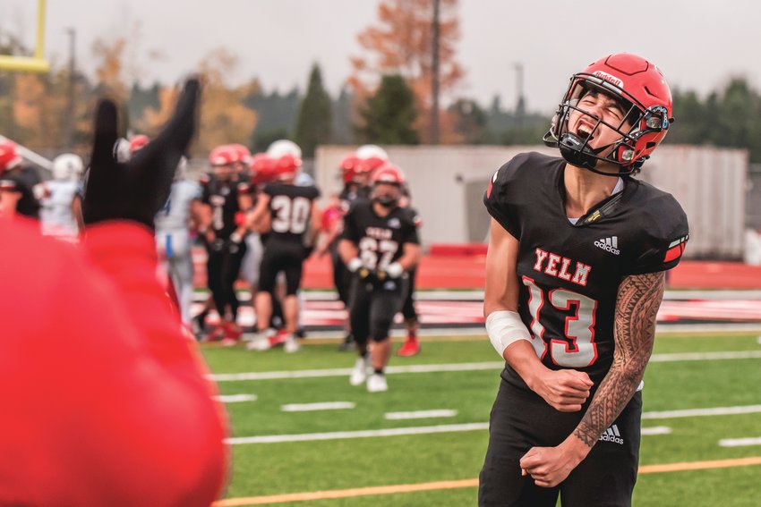 Yelm&rsquo;s Quarterback Palaina Hooper (13) yells as coaches clap while celebrating a touchdown Saturday afternoon.