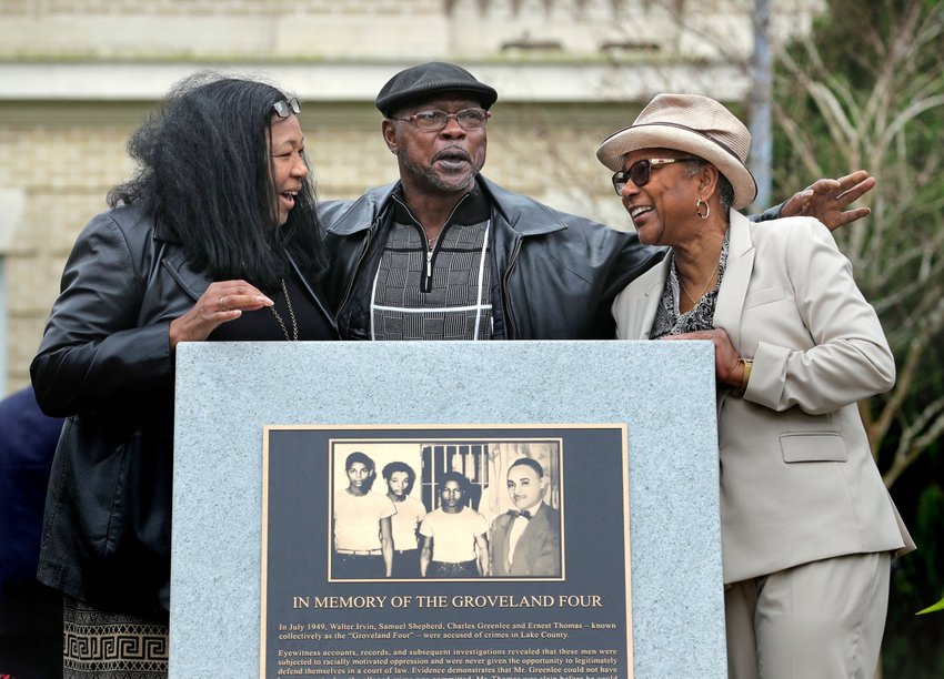Relatives of the Groveland Four gather at the just-unveiled monument in front of the Lake County historical courthouse in Tavares, Fla., Friday, February 21, 2020. Gov. Ron DeSantis, elected officials and community leaders participated in the unveiling ceremony, honoring the four men who were falsely accused of a rape in 1949. From left, Vivian Shepherd, niece of Sam Shepherd; Gerald Threat, nephew of Walter Irvin; Carol Greenlee, daughter of Charles Greenlee. (Joe Burbank/Orlando Sentinel)