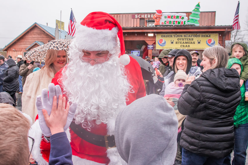 .Santa high-fives kids outside the Adna Grocery Store on Saturday. After the event, which included a tree lighting ceremony, Jim Smith of Adna Grocery wrote: &ldquo;What a great day it was. Cindy and I would like to thank everyone that came to Santa Comes to Adna. We hope that everyone had a great time. So sorry that the helicopter couldn&rsquo;t fly because of the weather conditions but we had an offer from Sheriff Rob Snaza to bring Santa and Mrs. Claus to the Adna Grocery. A big thanks to Sheriff Sanza and his motorcycle officers. You made the day. Another big thanks to our helpers David and Dena Larson, Santa and Mrs. Santa, Presley Smith and her senior helpers, District 6 Fire Department, The Chronicle, KITI and everyone that donated to this awesome event. (Saturday morning) David Larson and I started out delivering Christmas dinners to 13 families. We delivered donated smoked turkeys and various other food items and then we came back to the Adna Grocery to help set up for Santa&rsquo;s arrival. Every kid that came to visit Santa was able to sit on Santa&rsquo;s lap and receive a gift.&rdquo;