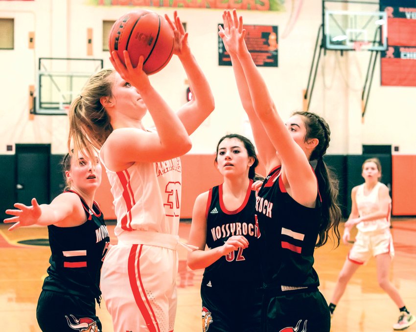 FILE PHOTO -- Mossyrock defenders swarm Rainier&rsquo;s Isabella Holmes (30) Thursday night.