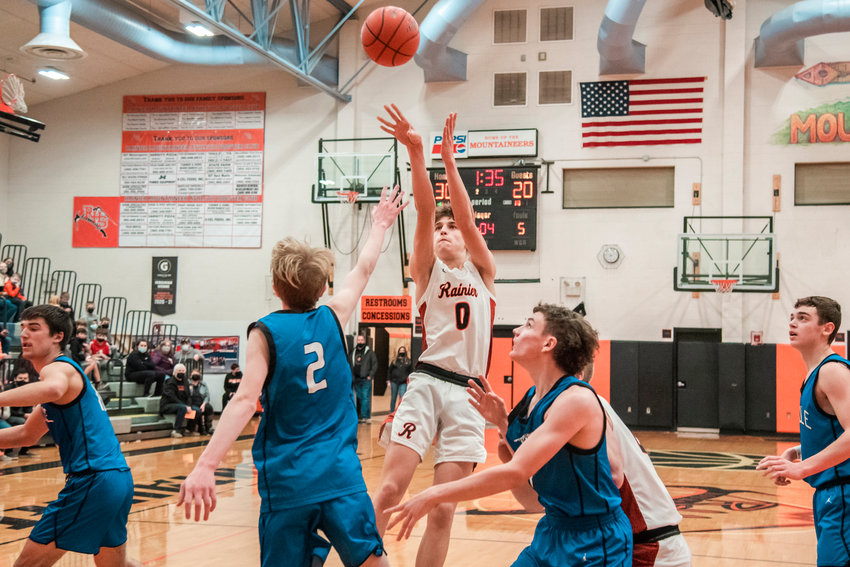 Rainier&rsquo;s Ian Sprouffske (0) shoots over Toutle defenders during a game Thursday night.