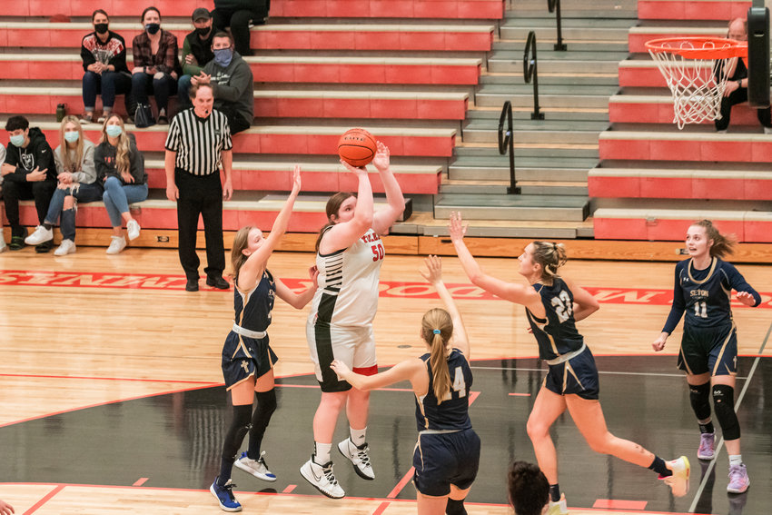 FILE PHOTO -- Toledo&rsquo;s Taylor Langhaim (50) looks to shoot over Seton Catholic defenders during a game Saturday night.