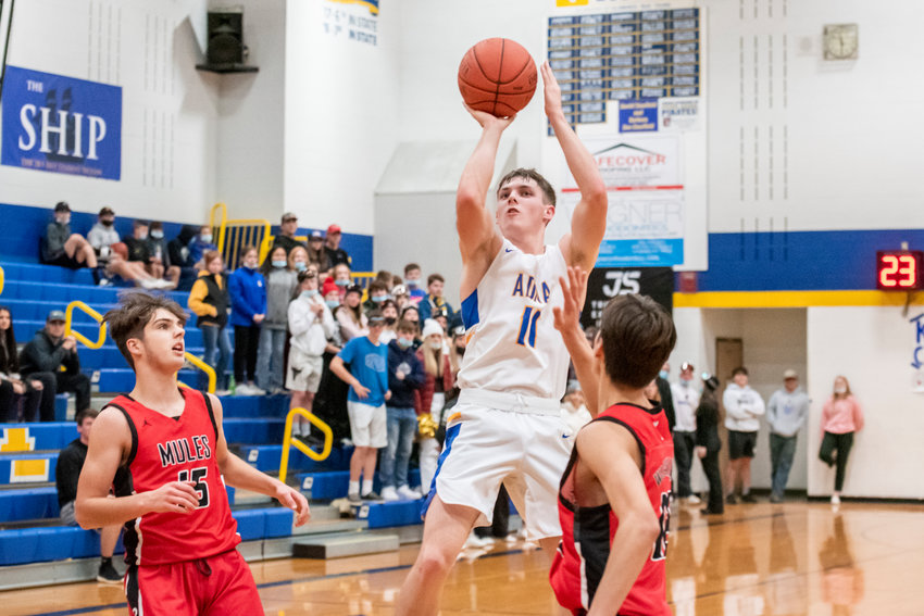 Adna&rsquo;s Chase Collins (11) shoots over Wahkiakum defenders during a game earlier this season.