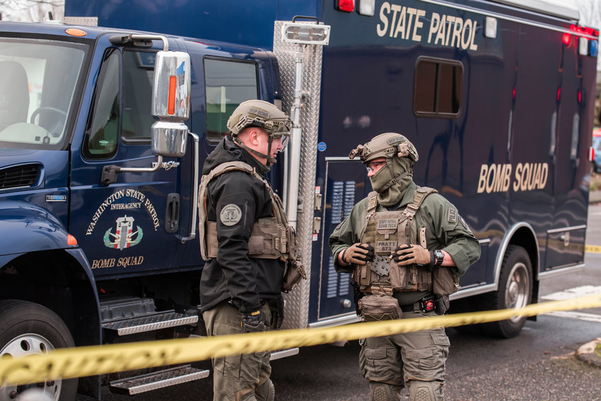 State Patrol Bomb Techs suit up while responding to a scene at the 1st Security Bank location at 604 South Tower Avenue in Centralia after reports of an explosion in the area Sunday morning.