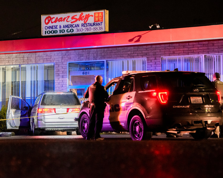 Chehalis Police surround a vehicle outside the Ocean Sky Chinese &amp; American Restaurant Monday night as police tape stretches around the building.