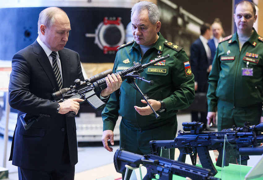 Russian President Vladimir Putin and Defence Minister Sergei Shoigu tour a military gear exhibition before the annual meeting of the Defence Ministry board in Moscow on Dec. 21, 2021. (Mikhail Metzel/Sputnik/AFP via Getty Images/TNS)
