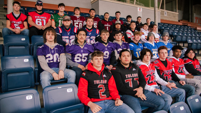 Athletes selected for the All-Area Football team pose for a photo at Tiger Stadium in Centralia sporting their school&rsquo;s football jerseys.