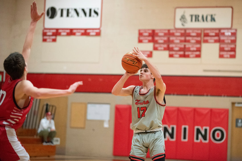 Tenino point guard Will Feltus (12) lines up a 3-point shot against Toledo on Dec. 22.