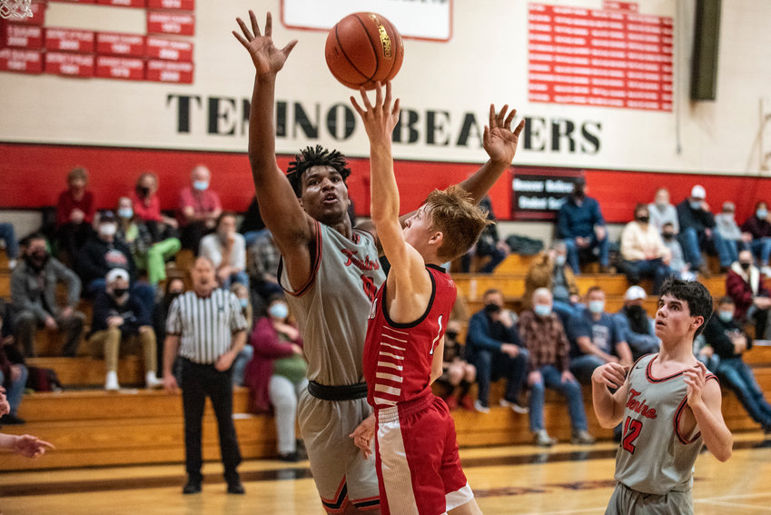 Toledo's Jake Cournyer (1) drives against Tenino's Takari Hickle (44) for a layup during a non-league matchup in Tenino on Wednesday.
