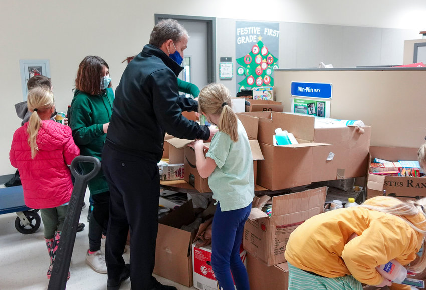 Battle Ground Public Schools Superintendent Denny Waters helps students sort through donated items at Captain   Strong Primary.