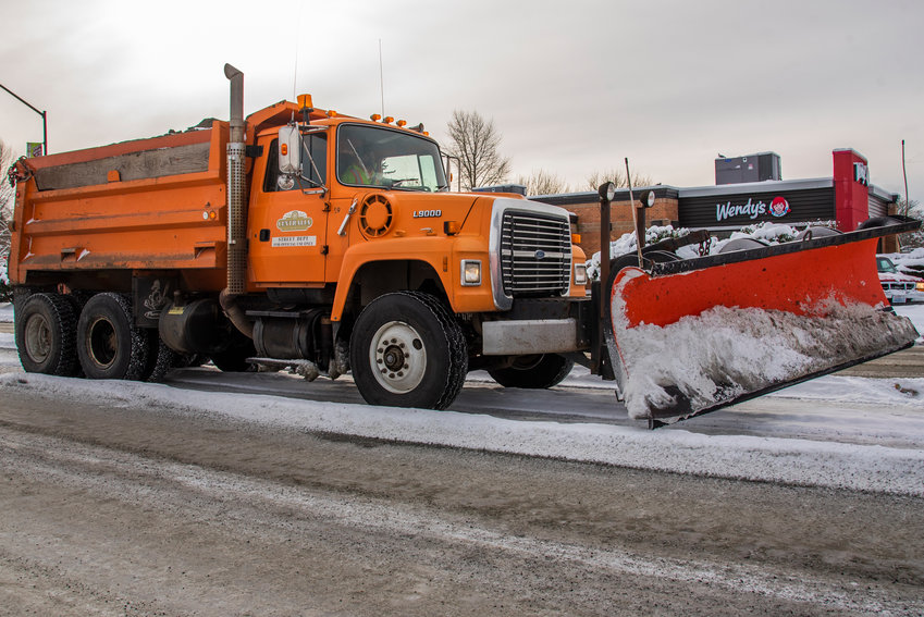 A Centralia Street Department snow plow drives down Harrison Avenue in December 2021.