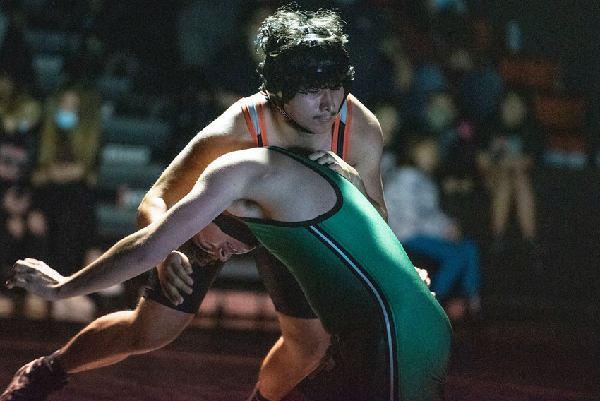 Centralia junior Christopher Isai Mendoza-Ponce, top, defends against a takedown attempt by a Tumwater wrestler on Jan. 5.