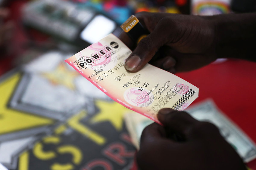 George Hollins buys a Powerball ticket at the Shell Gateway store on March 26, 2019, in Boynton Beach, Florida. (Joe Raedle/Getty Images/TNS)