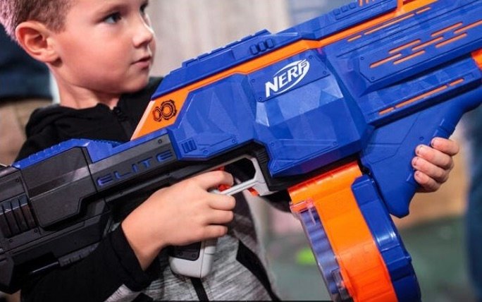 A boy holds a Nerf gun.