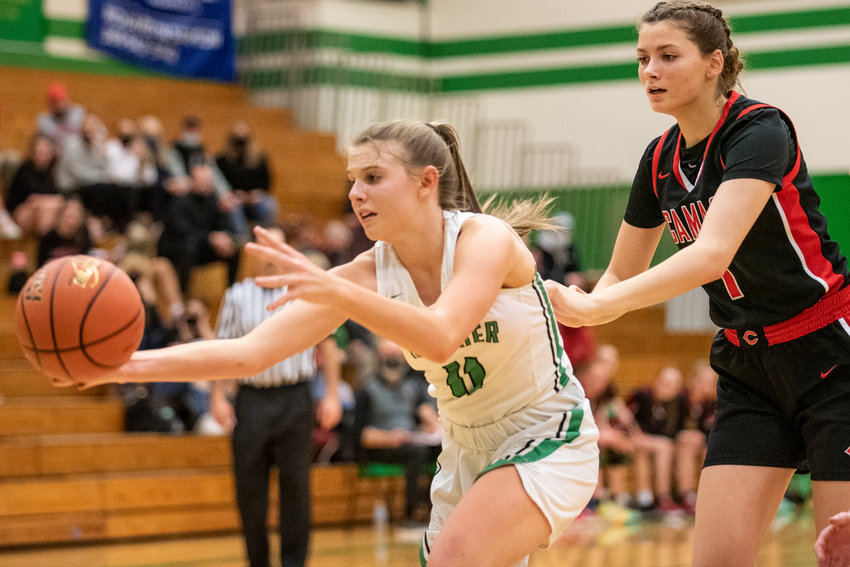 Tumwater's Kylie Waltermeyer (11) grabs a loose ball against Camas on Jan. 10.