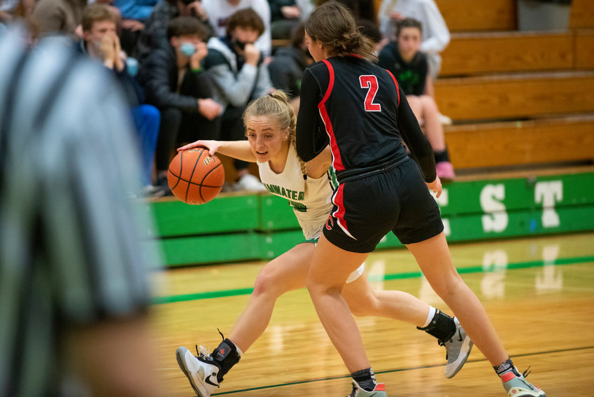 Tumwater's Isabella Lund (23) drives against Camas' Kendall Maris (2) during a home game on Jan. 10.