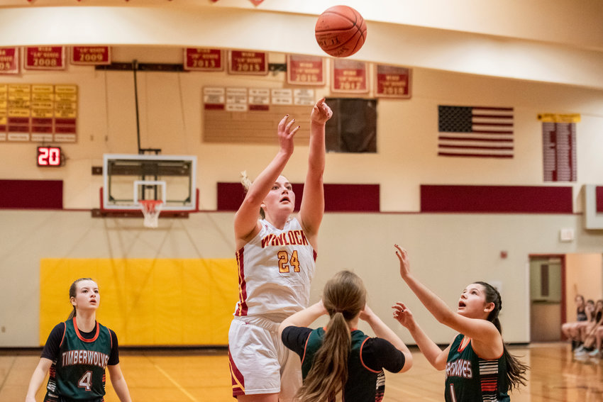 Winlock&rsquo;s Addison Hall (24) scores over Timberwolves as they defend during a game Tuesday night.