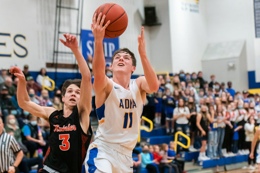 Adna&rsquo;s Chase Collins (11) goes up with the ball during a game against Rainier Friday night.
