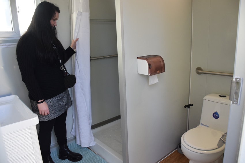 Battle Ground Deputy Mayor Cherish DesRochers speaks about the amenities located in a &ldquo;shower pod&rdquo; installed at Immanuel Lutheran Church in Vancouver.