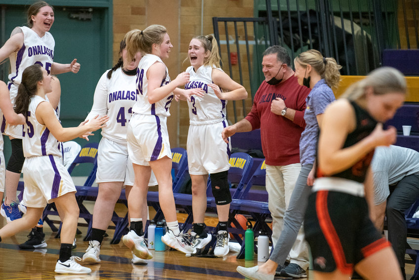 Onalaska players leap in celebration after completing a come-from-behind victory, 39-37 over visiting Rainier in a Central 2B League matchup of top-10, state-ranked teams.
