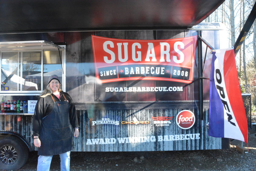 Lynnae Oxley stands in front of her Sugars Barbecue food truck.