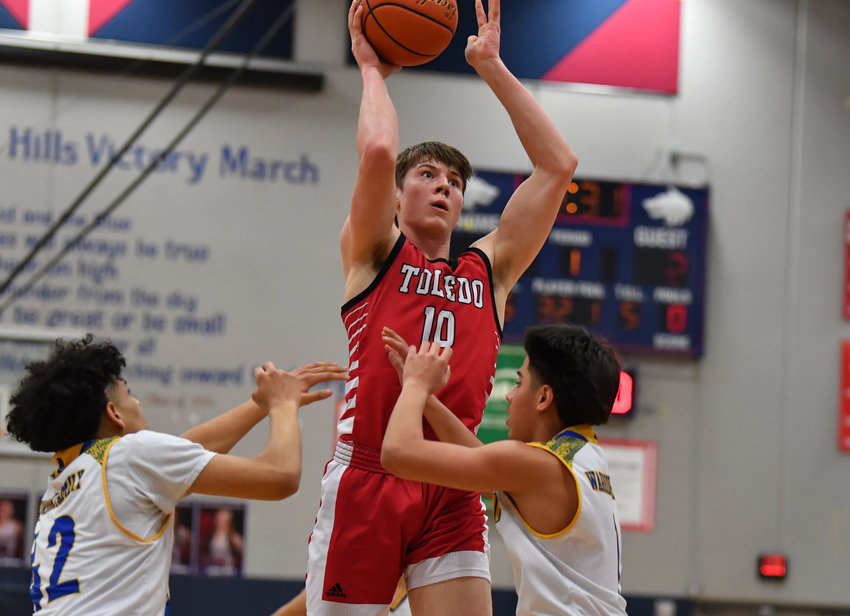 Toledo&rsquo;s Carson Olmstead shoots over two Chief Leschi players in the district playoffs at Black Hills High School on Feb. 11.