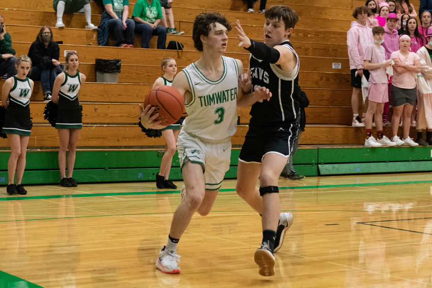 Tumwater guard Luke Reid drives baseline against Woodland in the first round of the 2A District IV playoffs in Tumwater Feb. 12.