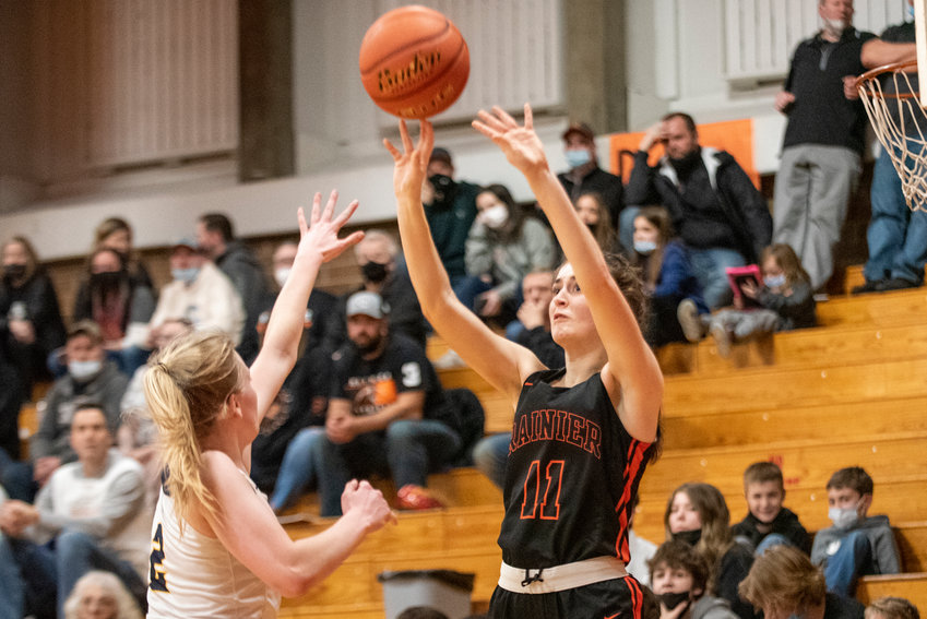 Rainier's Faith Boesch (11) shoots a 3-pointer against Forks in a loser-out, 2B District IV basketball game on Feb. 15. Boesch broke the tournament's single-game 3-point record with 11 treys.