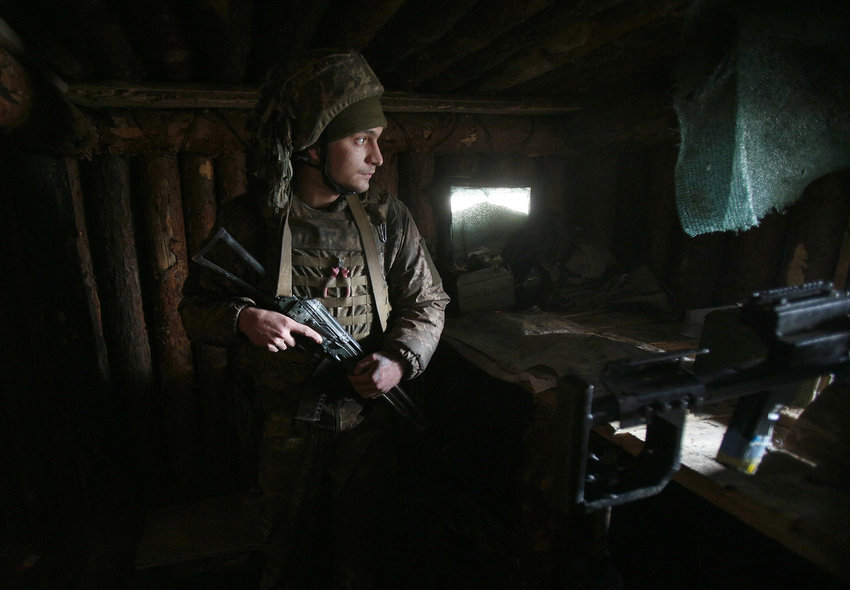 A Ukrainian serviceman keeps watch at a position on the front line with Russia-backed separatists near the town of Schastia, near the eastern Ukraine city of Lugansk, on Feb. 23, 2022. (Anatolii Stepanov/AFP via Getty Images/TNS)
