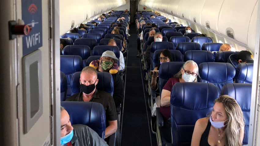Masked passengers fill a Southwest Airlines flight from Burbank, California to Las Vegas. So far this year, nearly 1 in 6 flight attendants nationwide has had a physical experience with an unruly passenger, mostly involving people who were drunk and obstinate about face mask rules. (Christopher Reynolds/Los Angeles Times/TNS)