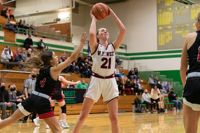 W.F. West forward Morgan Rogerson skies for a rebound against Archbishop Murphy in the regional round of the state tournament at Tumwater Feb. 25.