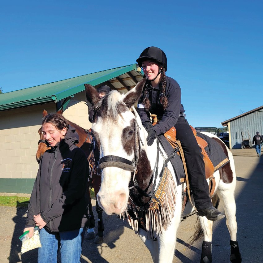 Angel Halle, right, rides Luna, and Miah Fultz, left, of the Battle Ground Equestrian Team are pictured.