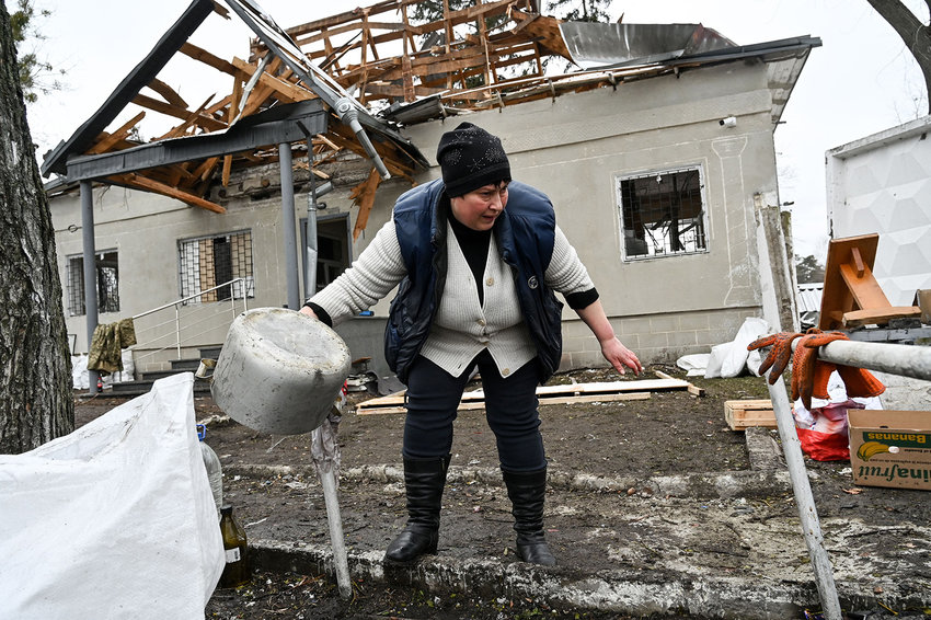 A woman gestures in front a building which was destroyed by recent shelling on a check-point in the city of Brovary outside Kyiv on March 1, 2022. (Genya Savilov/AFP via Getty Images/TNS)