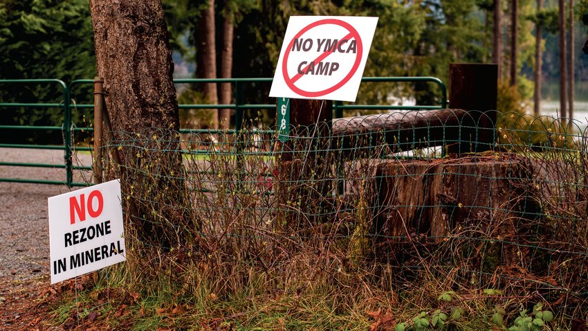 Signs posted on a property off Mineral Hill Road protest a proposed YMCA Camp around Mineral Lake last March.